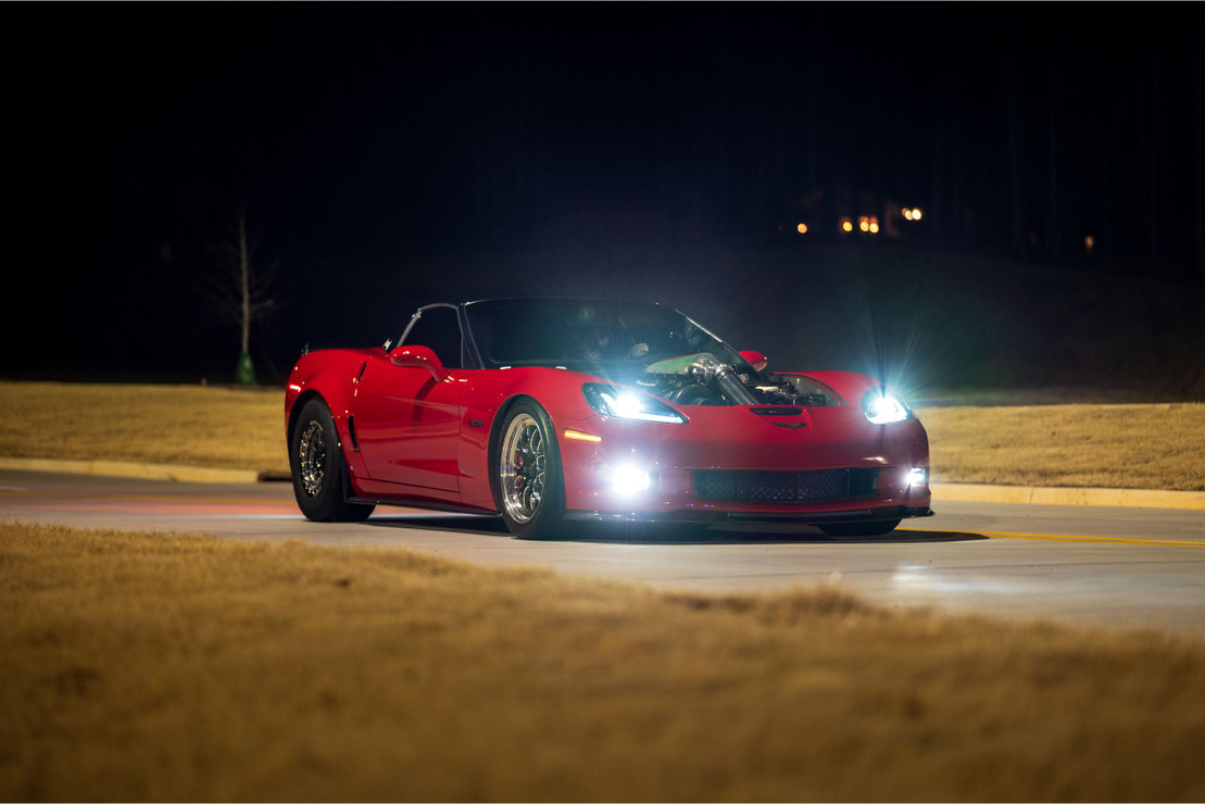 red-corvette-with-headlights-on